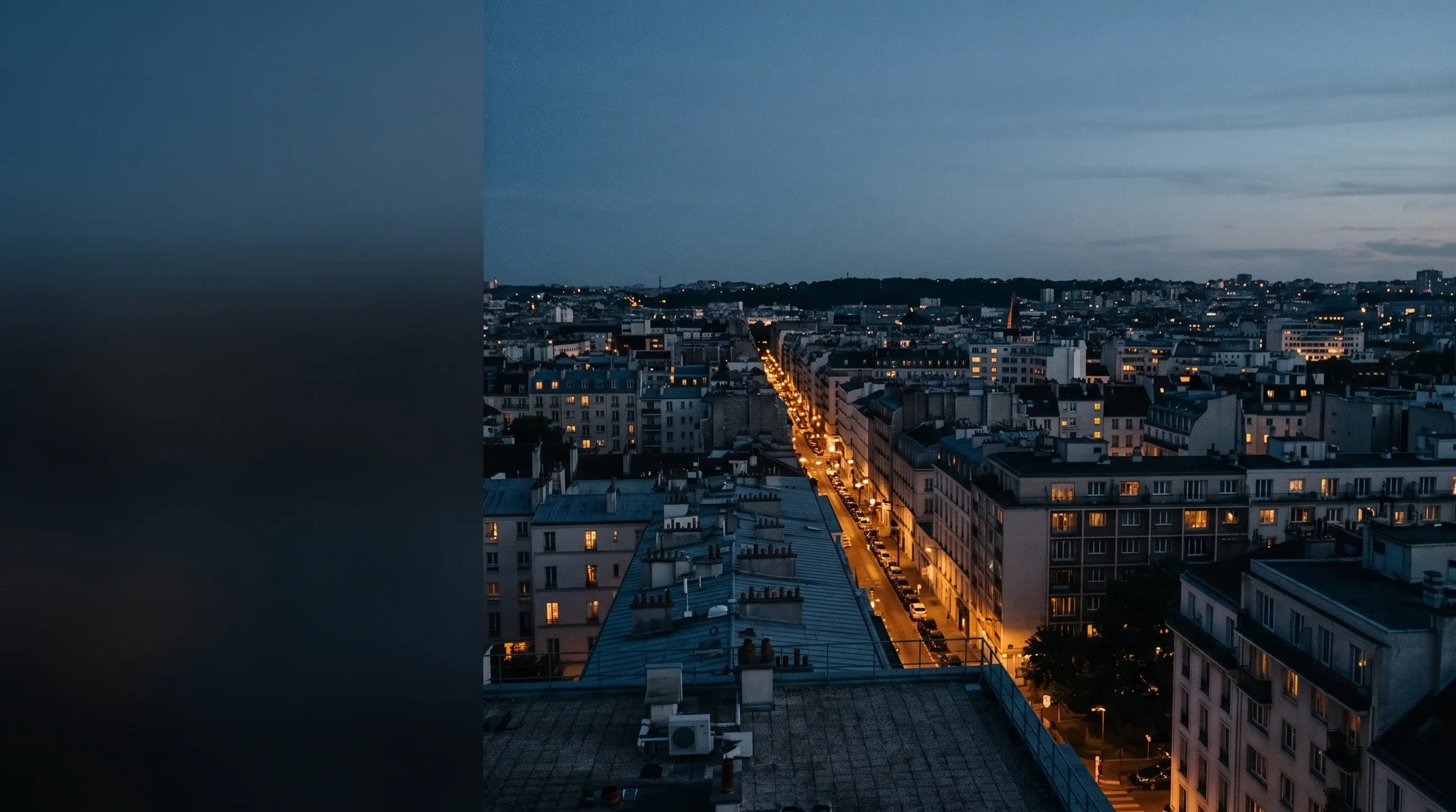 Oraș văzut de pe acoperiș la ora albastră, cu străzile luminate care se îndepărtează